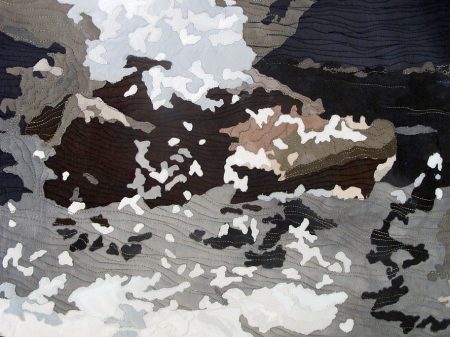 Collaged art quilt of rocky shore by the ocean in Maine)