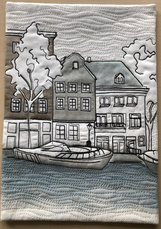 Alt text: Thread sketched and painted art quilt of iconic houses in Amsterdam