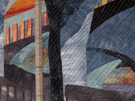 : Collaged art quilt of glass reflections of a parking garage in Spokane