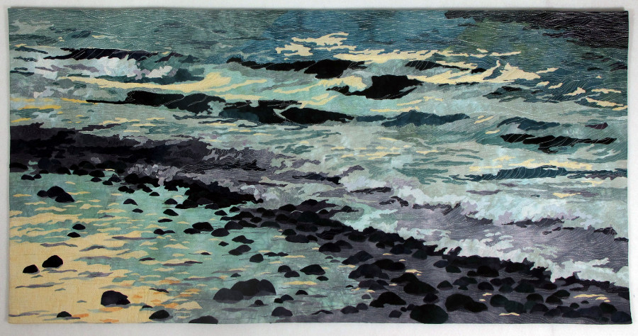 Collaged art quilt of an ocean beach at dusk