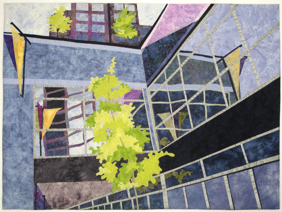 Collaged art quilt of Parkside Towers as seen from the patio of Bakery by the Lake in Coeur d’Alene, Idaho